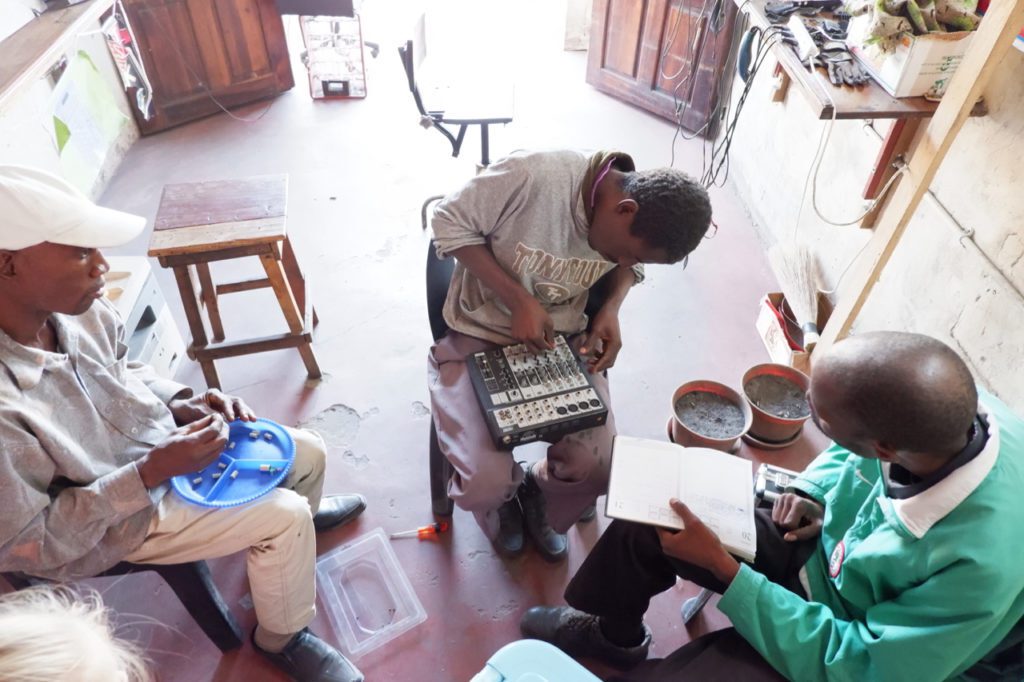 Men working on electronics.