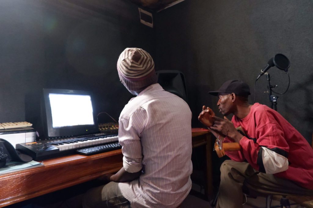 Musicians working in recording studio.